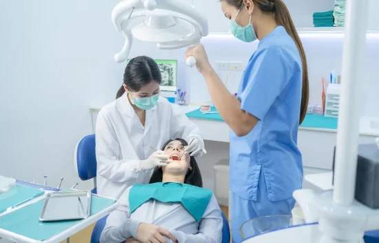 bigstock-Asian-Female-Dentist-Adjust-De-422674271_2_NHFmPHo